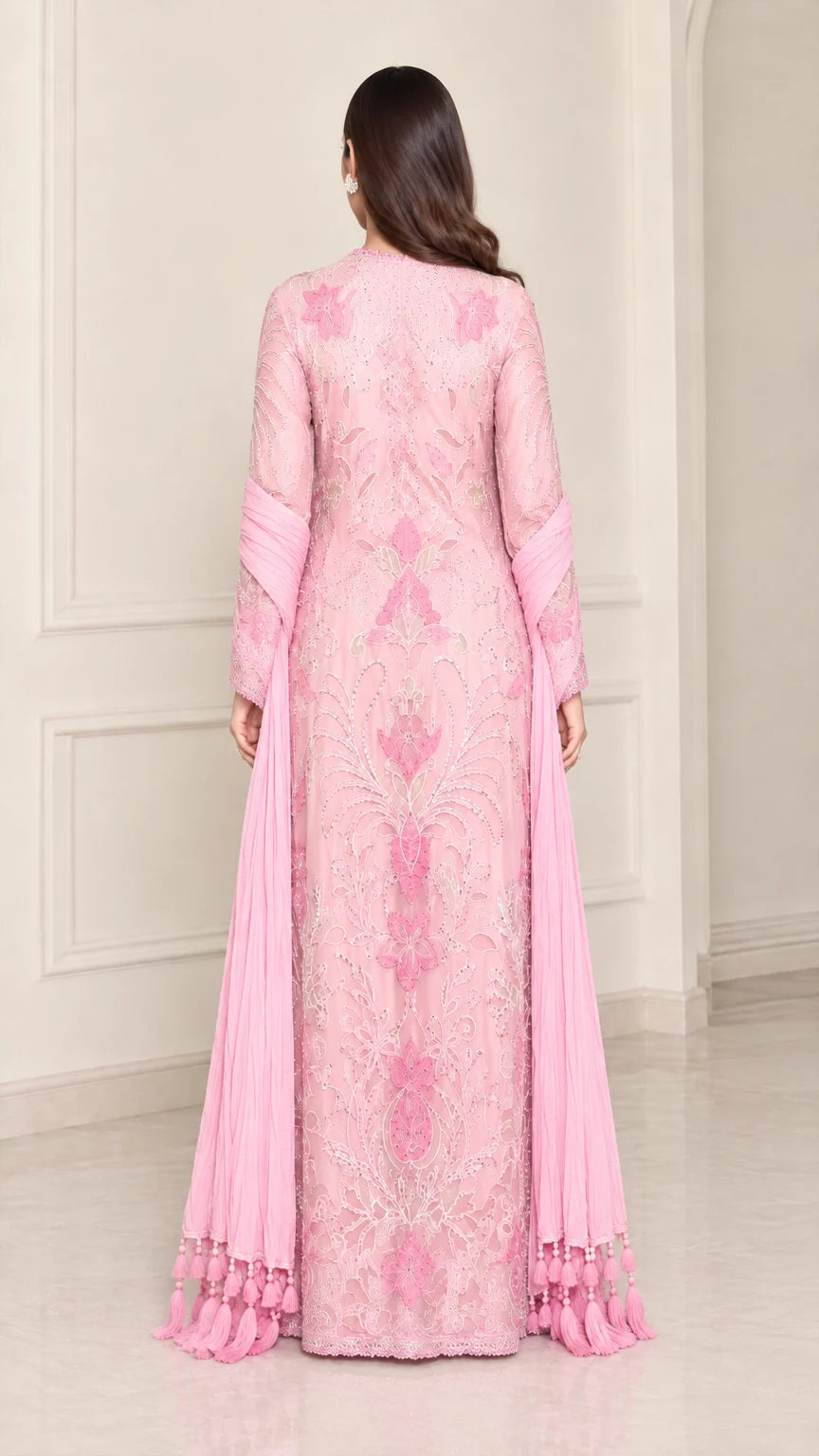 Back view of model wearing light pink embroidered maxi gown with long scarf