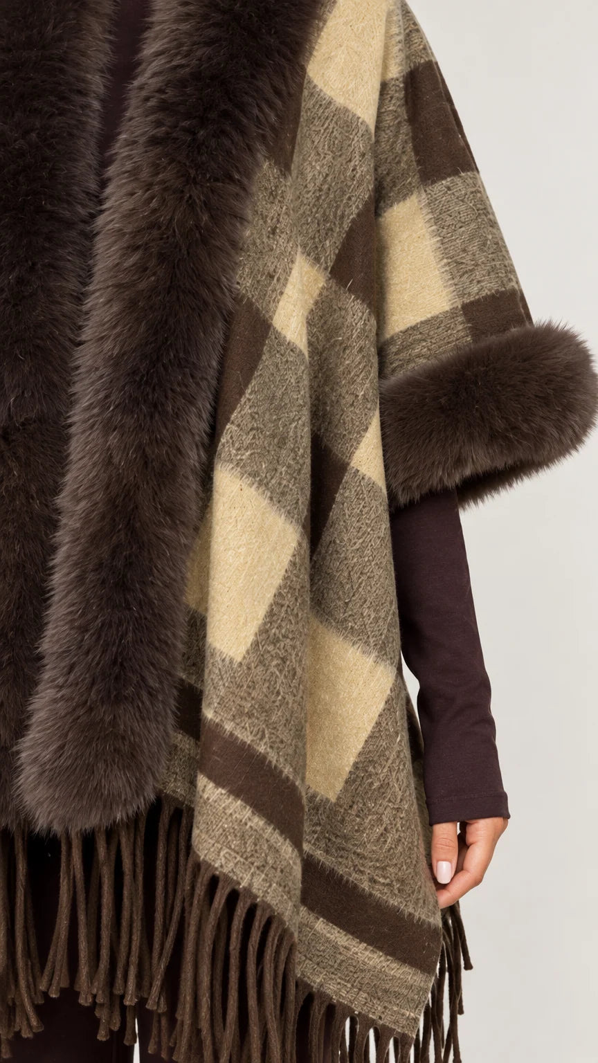 Close-up detail of soft plaid knit fabric and faux fur trim