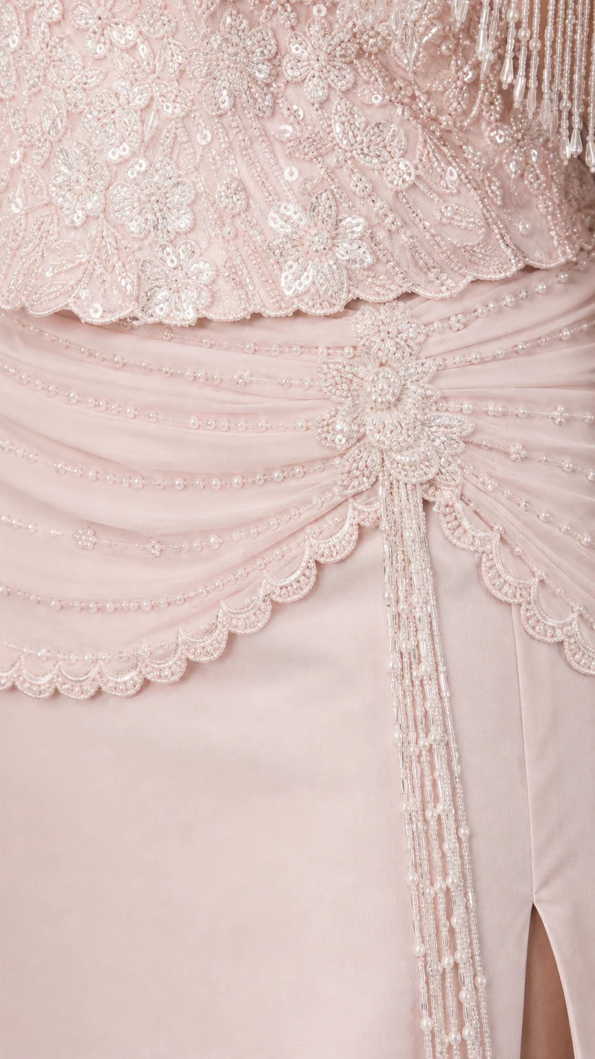 Close-up detail of ornate beadwork, fringe sleeves, and draped waist embellishment