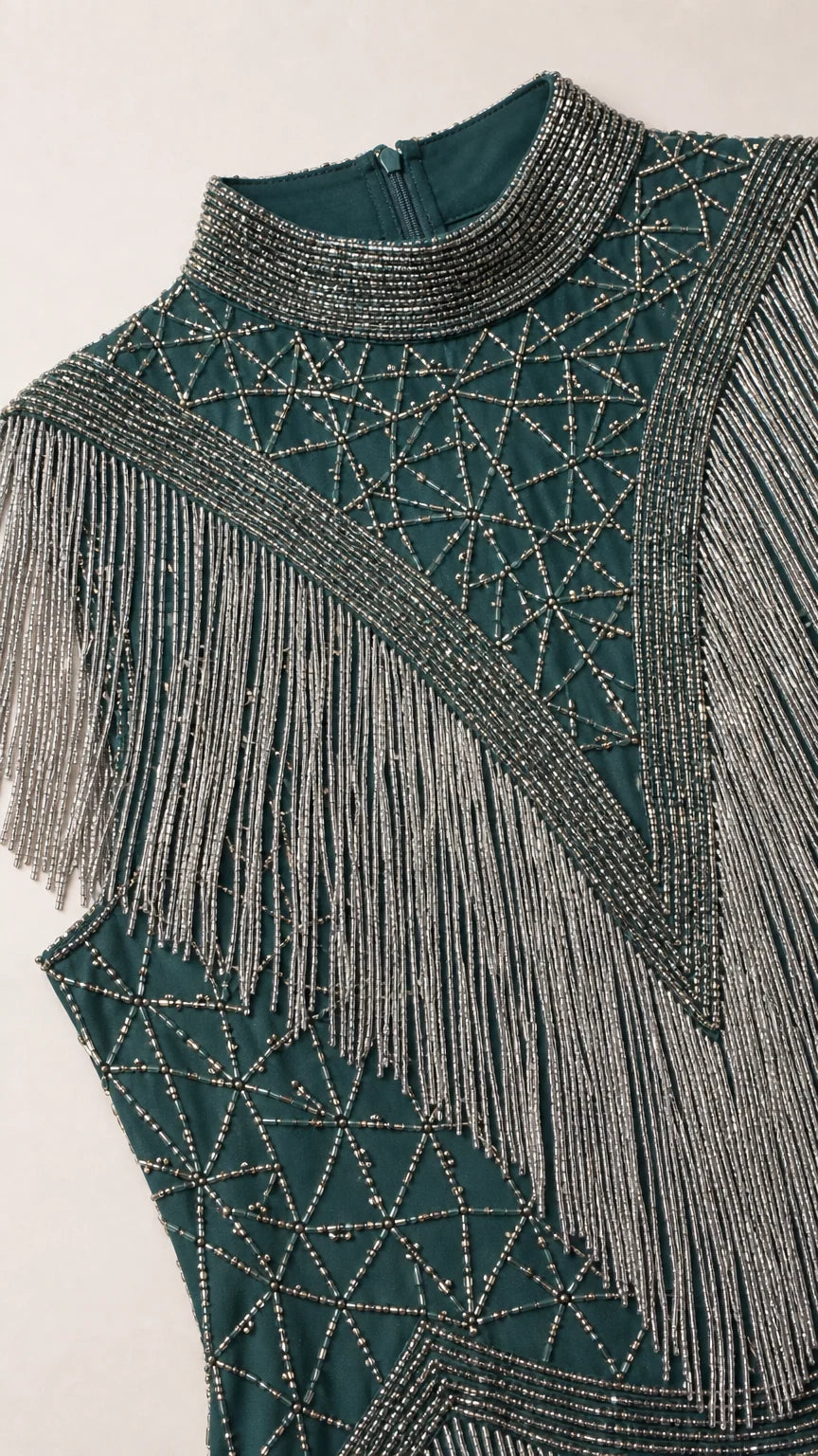 Close-up detail of high neckline and intricate geometric beadwork with fringe