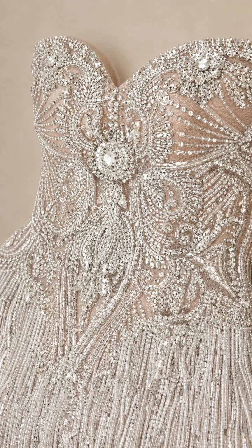Close-up detail of ornate crystal beading and tassel fringe on bodice