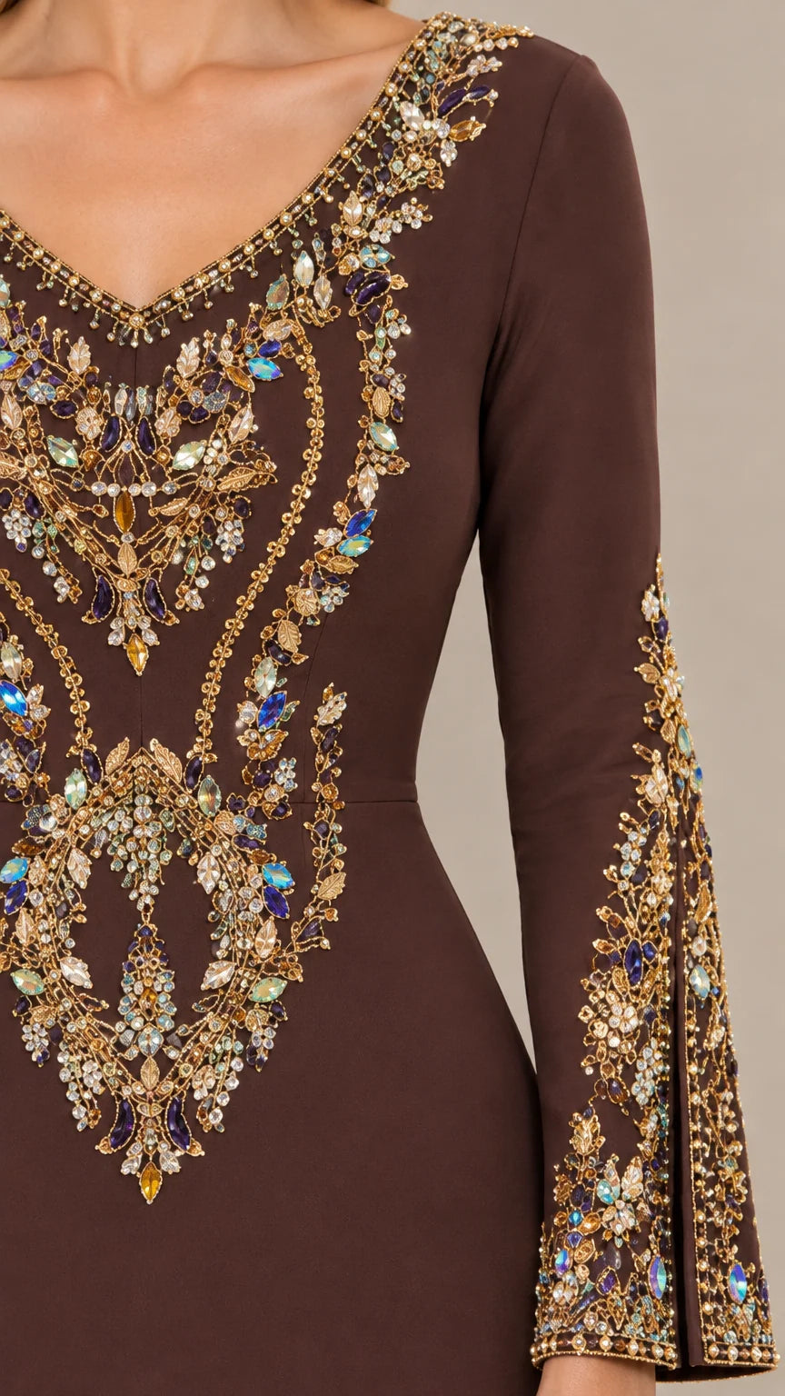 Close-up detail of ornate crystal and gem embellishments on bodice and neckline