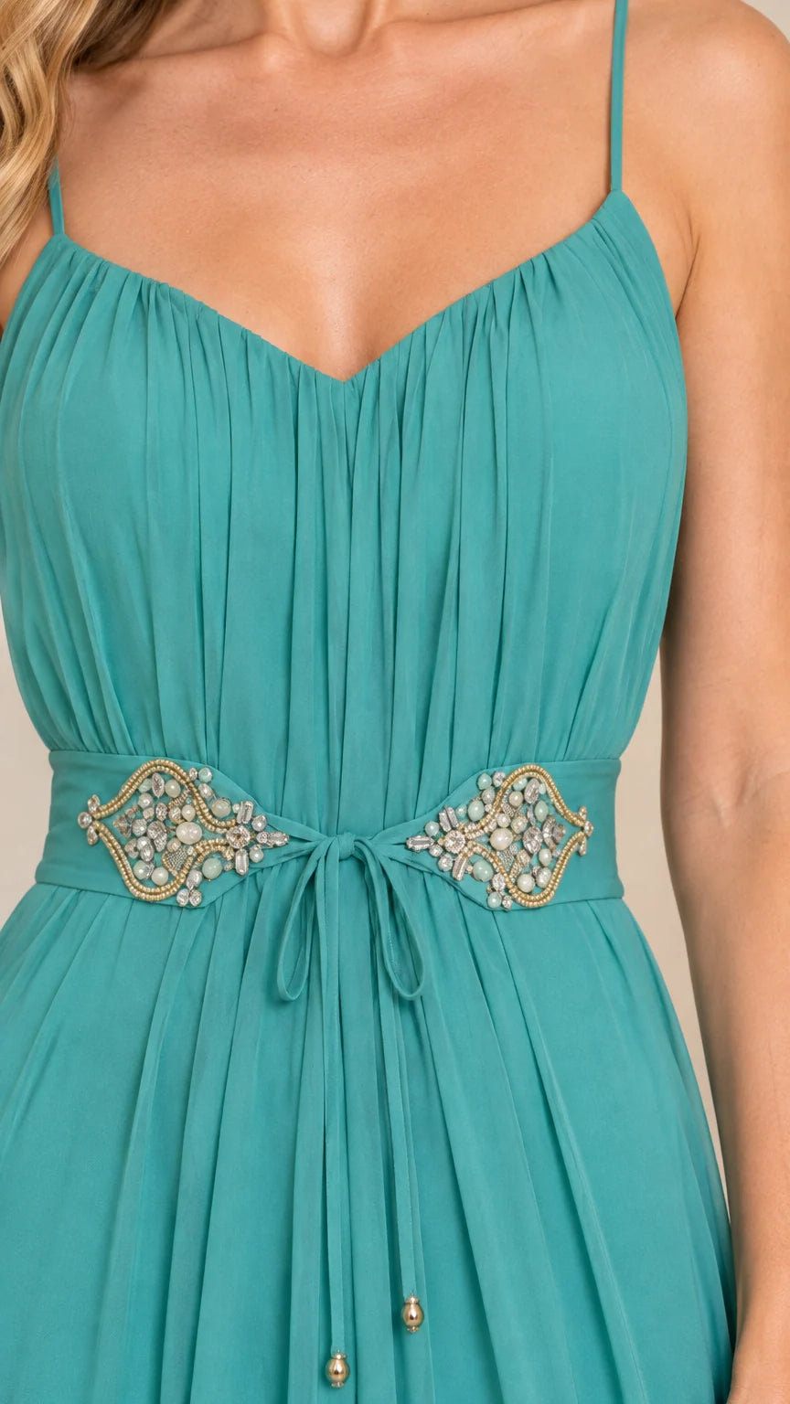 Close-up detail of pleated bust and crystal beaded embellishment with drawstring tie on teal gown