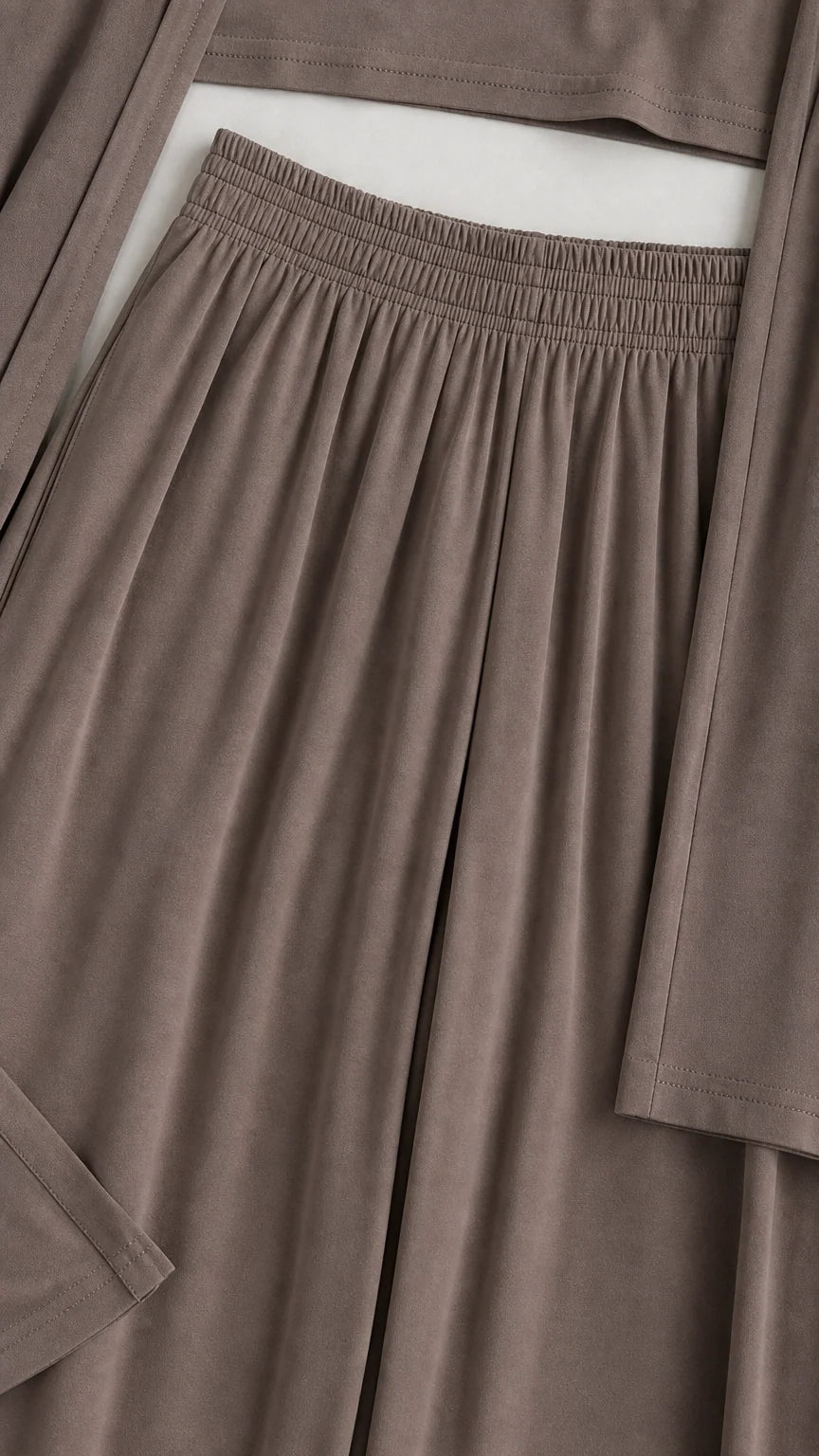 Close-up detail of the gathered elastic waistband, soft fabric texture, and sleeve cuff