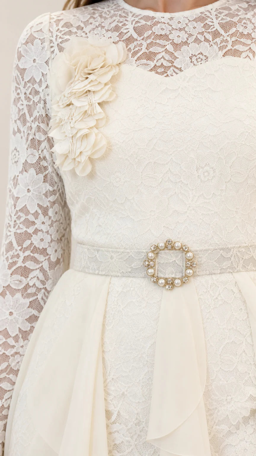 Close-up of off white floral lace bodice with 3D flower applique and jeweled belt buckle