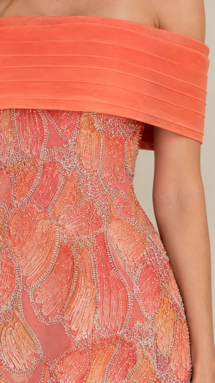 Close-up detail of coral beaded and sequined embroidery on formal gown