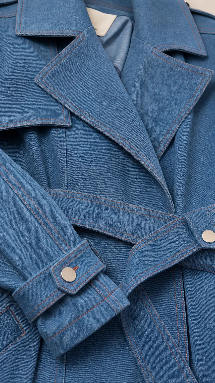 Close-up detail of Denim Blue jacket lapel, fabric weave, cuff tab, and contrast stitching