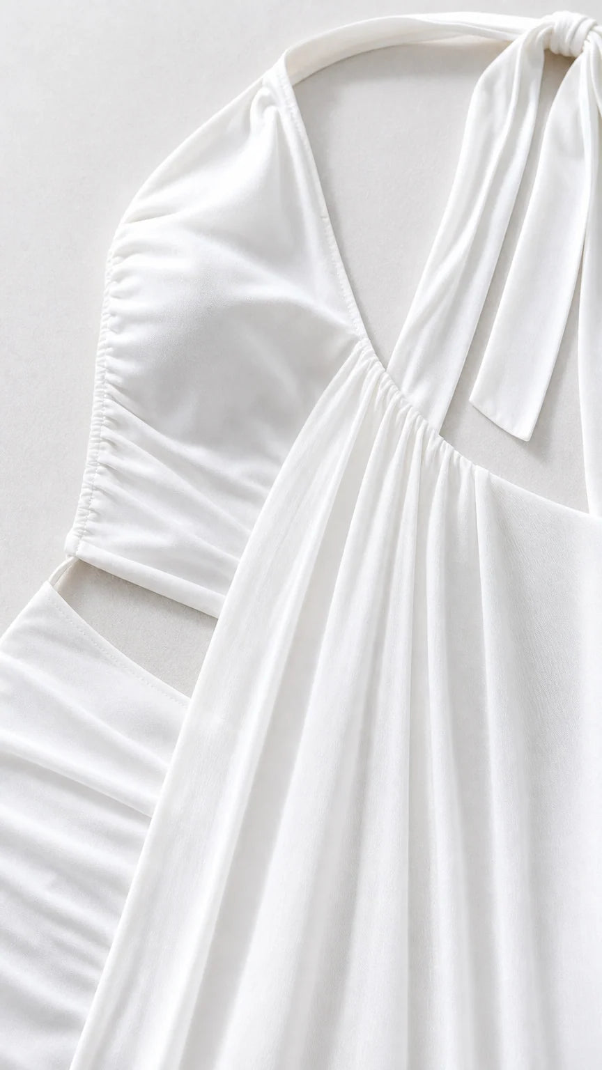 Close-up detail of white fabric, bodice, and cutout construction