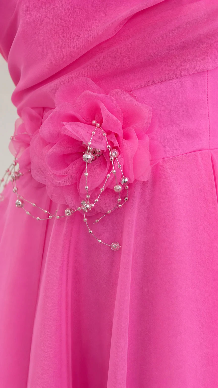 Close-up detail of 3D fabric flower appliqué and delicate beadwork