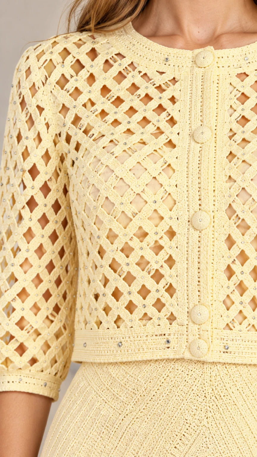 Close-up detail of geometric lattice knit pattern and button accents