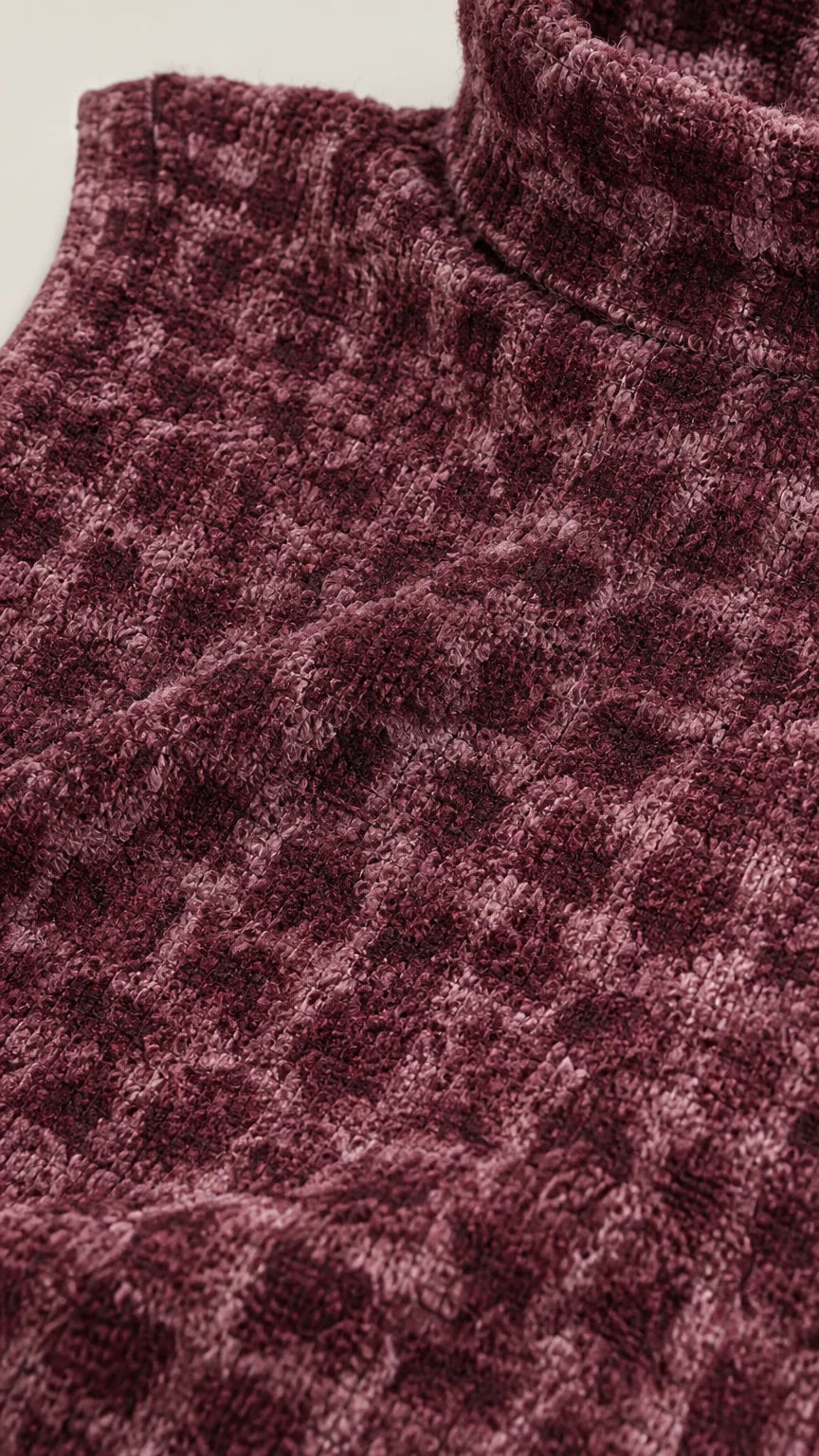 Close-up of fabric texture and mock neck detail in burgundy