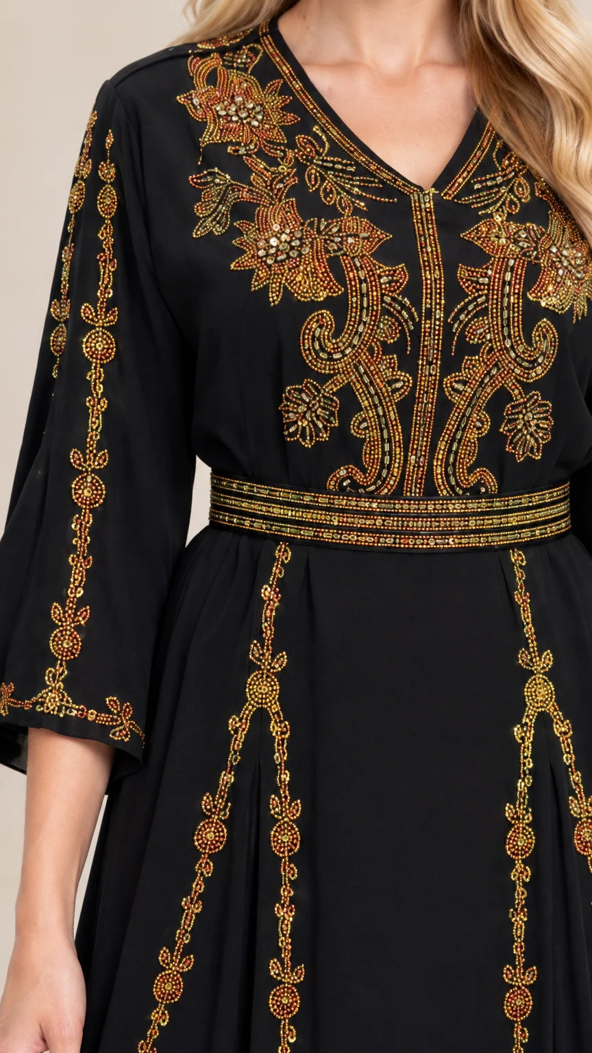 Close-up of intricate gold embroidery on black V-neck bodice and waist