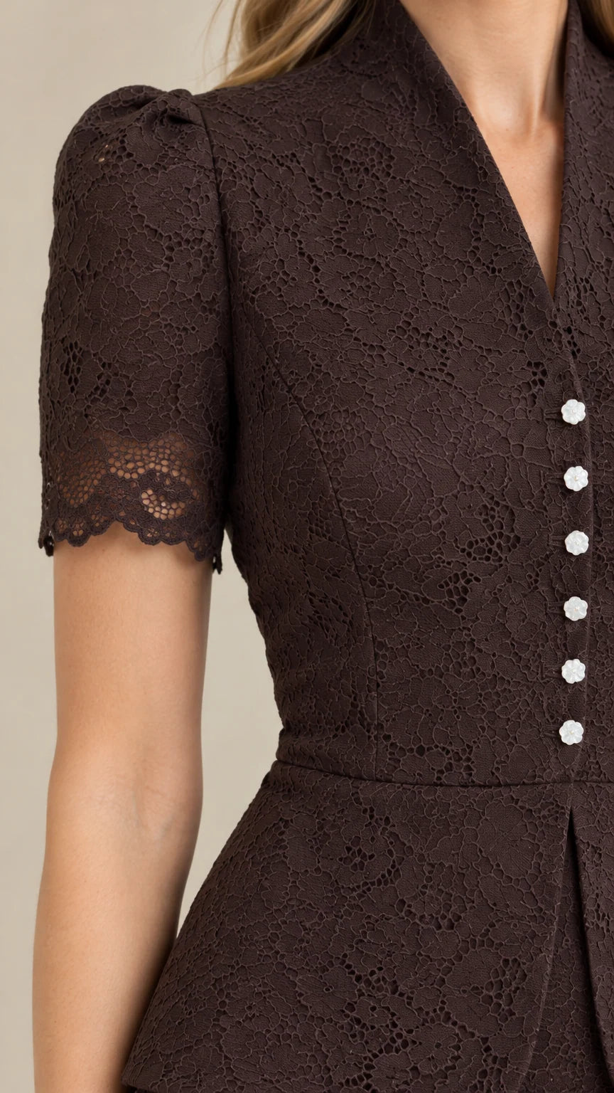 Close-up detail of espresso brown floral lace texture, puffed sleeve, and decorative buttons
