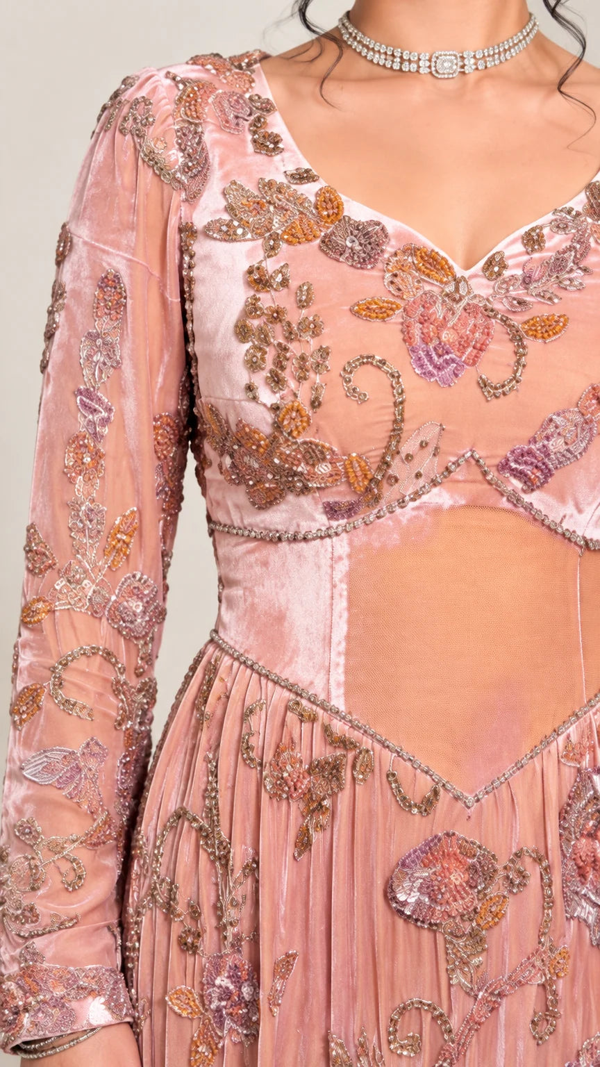 Close-up detail of sweetheart neckline, floral beadwork, and velvet panels on pink gown