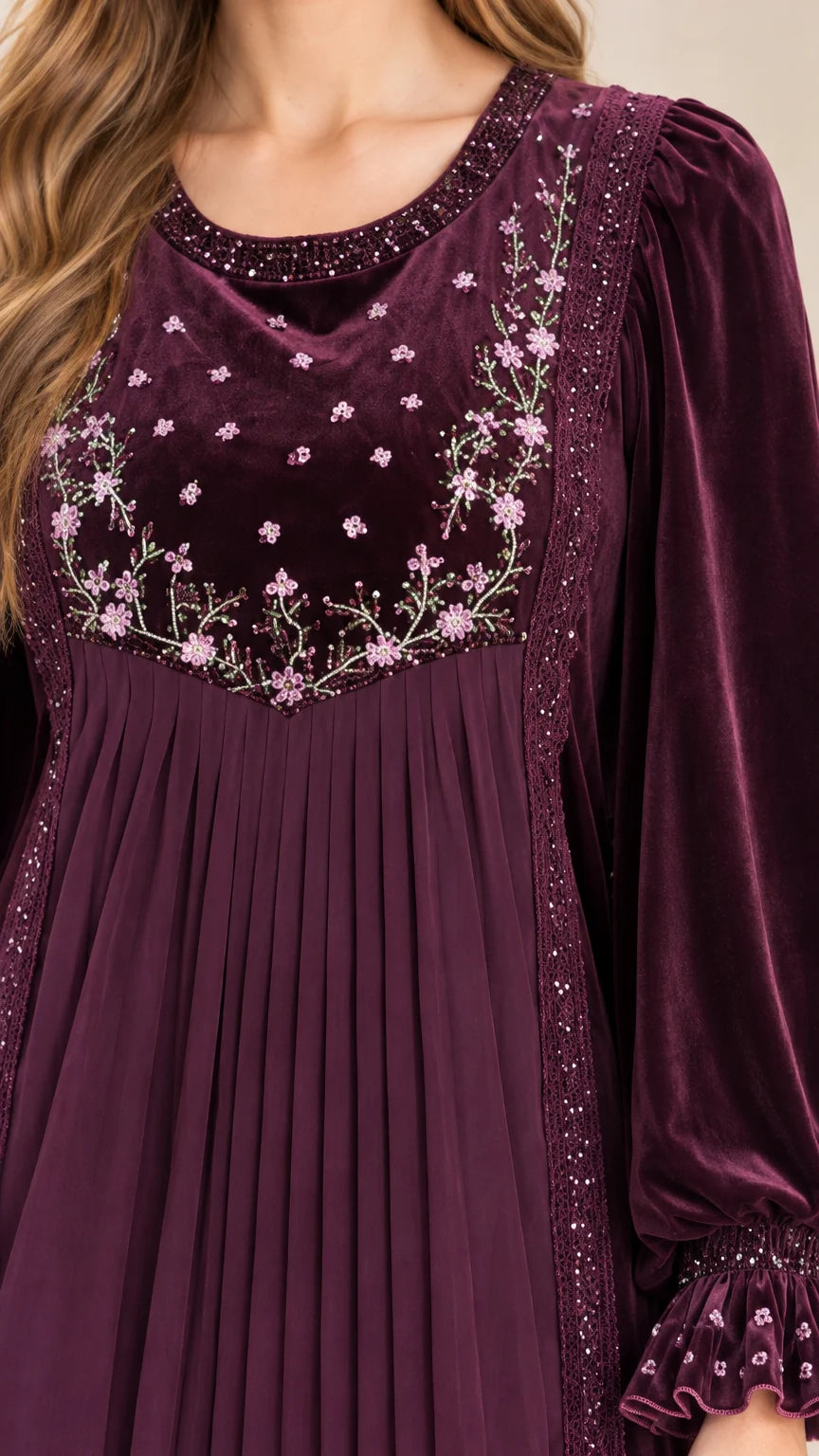 Close-up detail of floral embroidery, beading, and pleated panel on bodice