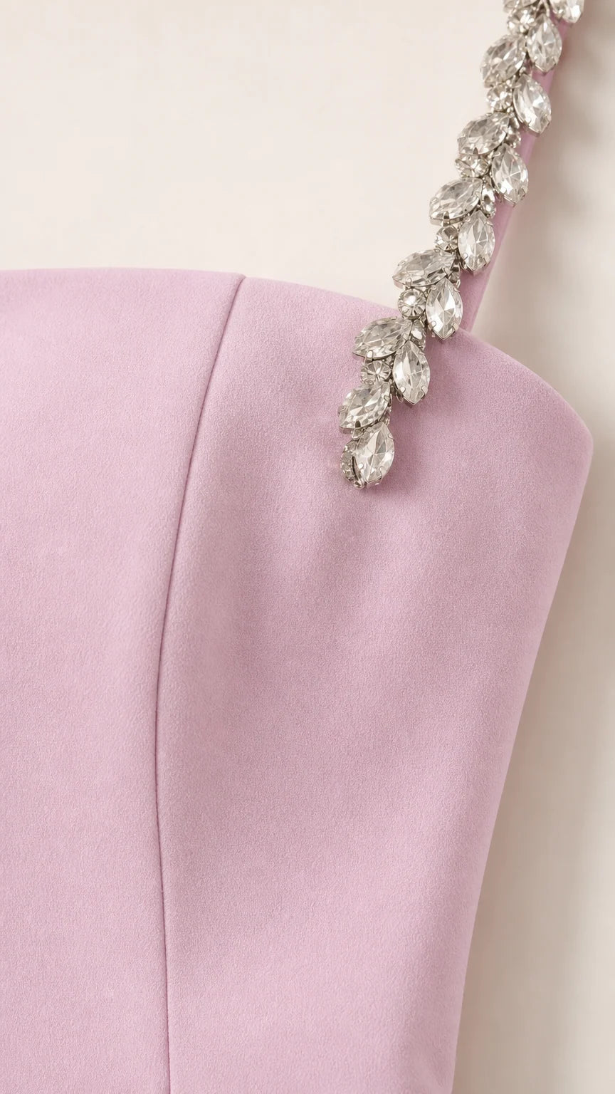 Close-up detail of crystal rhinestone embellishments on dress shoulder strap