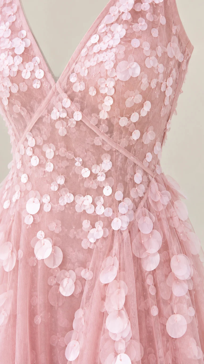 Close-up detail of blush pink bodice with layered petal paillette embellishments