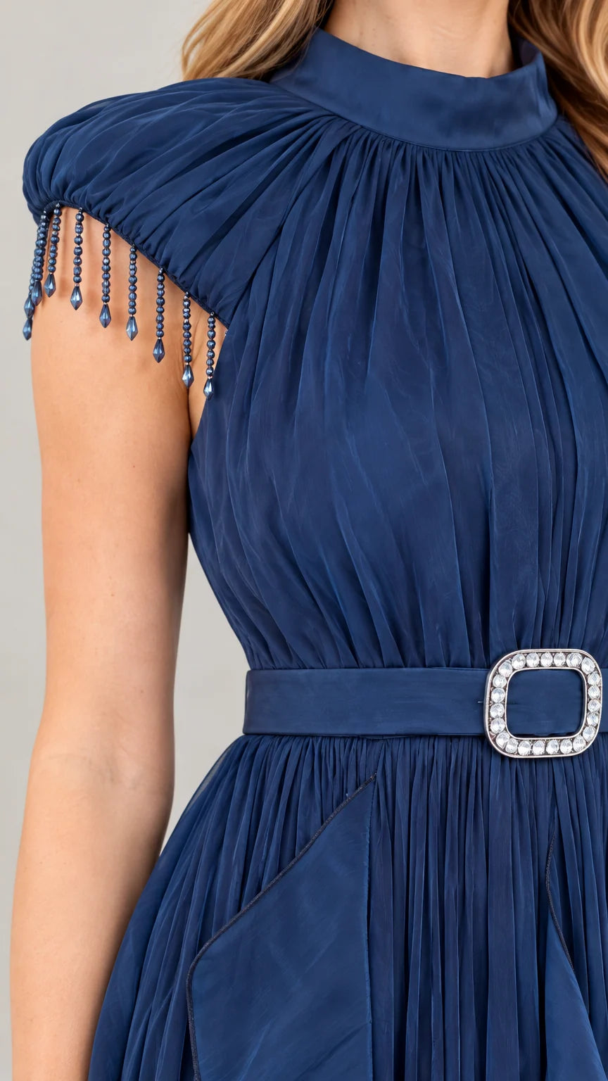 Close-up detail of beaded fringe cap sleeve, high gathered neckline, and rhinestone belt buckle in Navy Blue