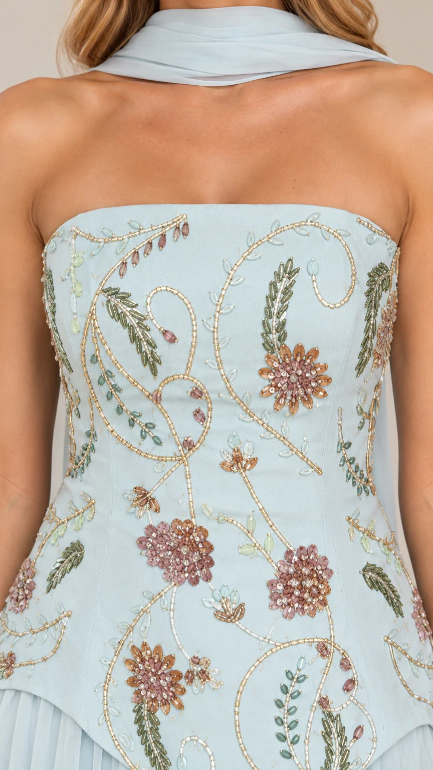 Close-up of sky blue strapless bodice with floral embroidery and beadwork