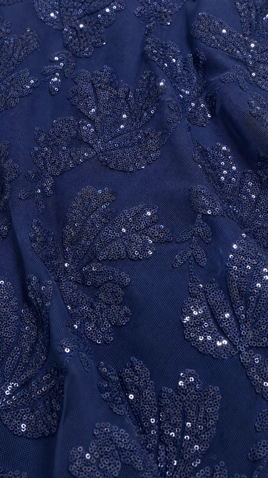 Close-up detail of navy sequin and lace embroidery