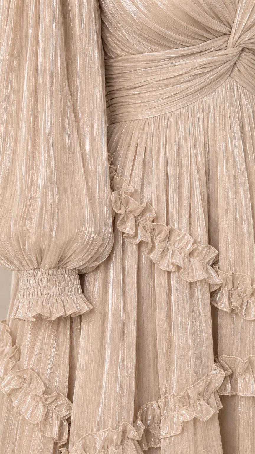 Close-up detail of pleated shimmer texture, smocked cuffs, and delicate ruffles
