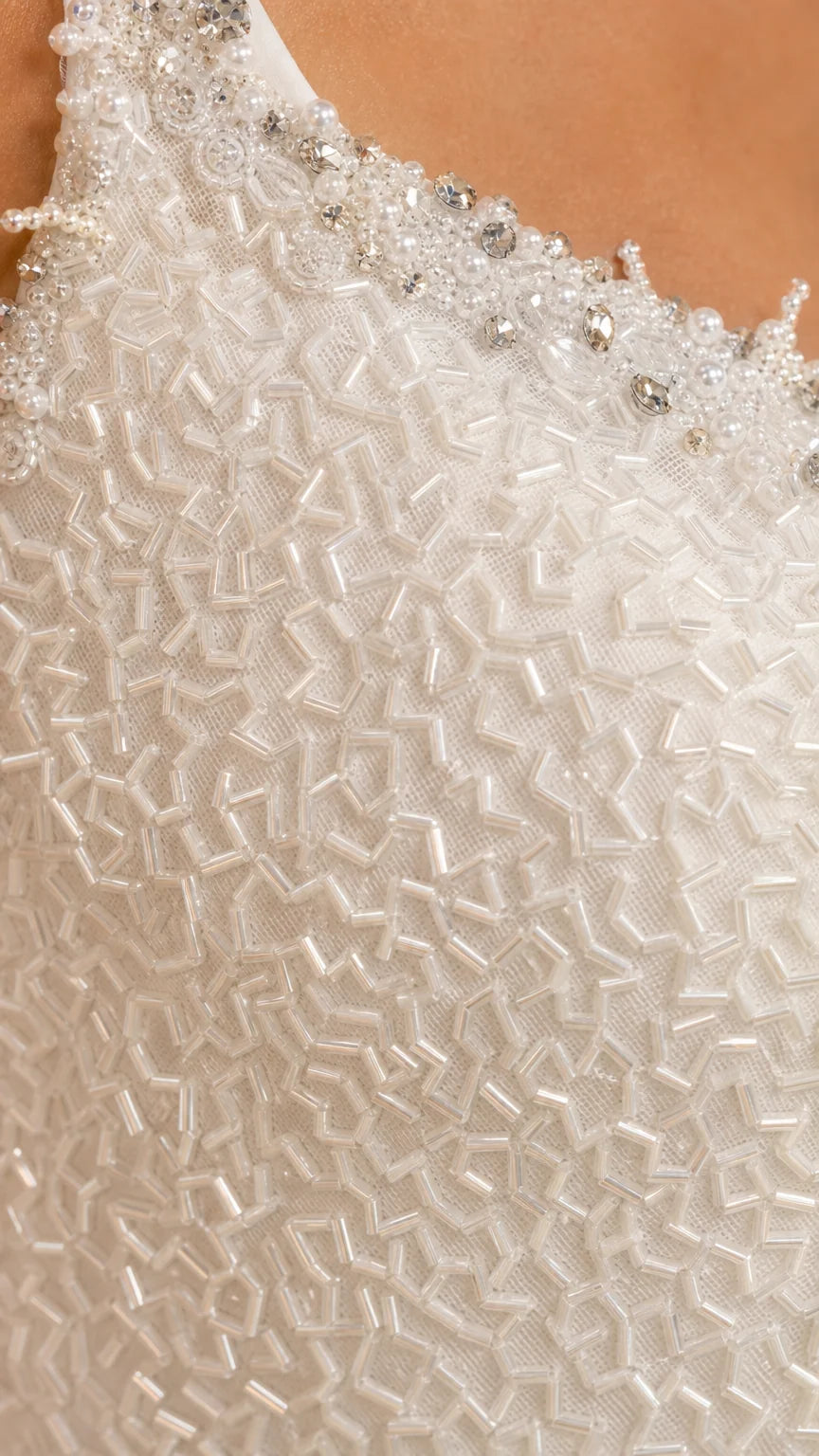 Close-up detail of crystal neckline embellishment and geometric beading