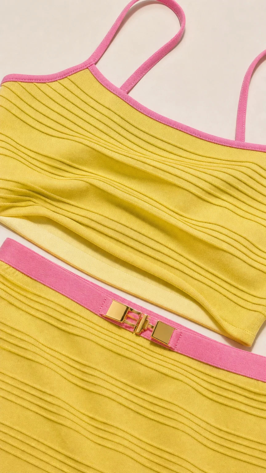 Close-up detail of yellow ribbed fabric and contrast pink trim