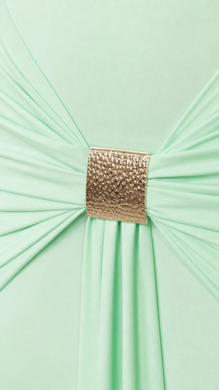 Close-up of gold metallic buckle gathering fabric on the dress