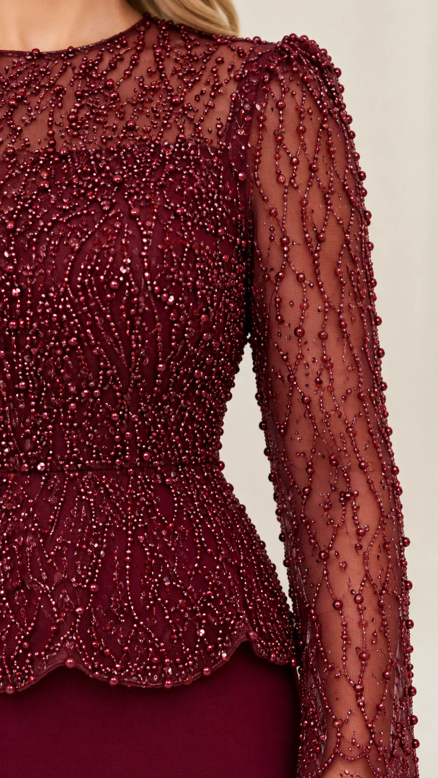 Close up detail of intricate beaded mesh bodice and scalloped peplum
