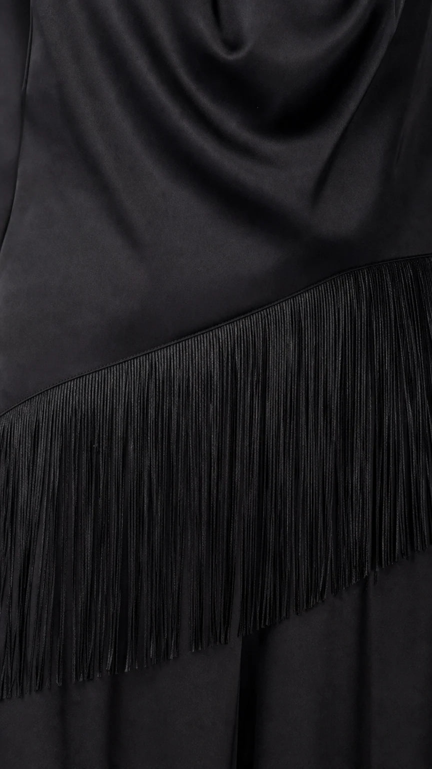 Close-up detail of fringe trim on black satin jumpsuit
