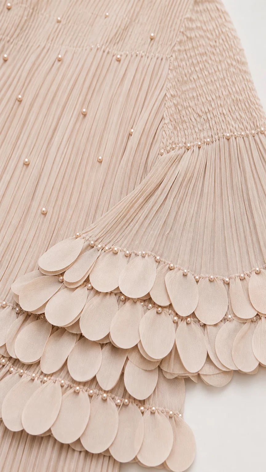 Close-up of pearl embellishments and scalloped sleeve hem