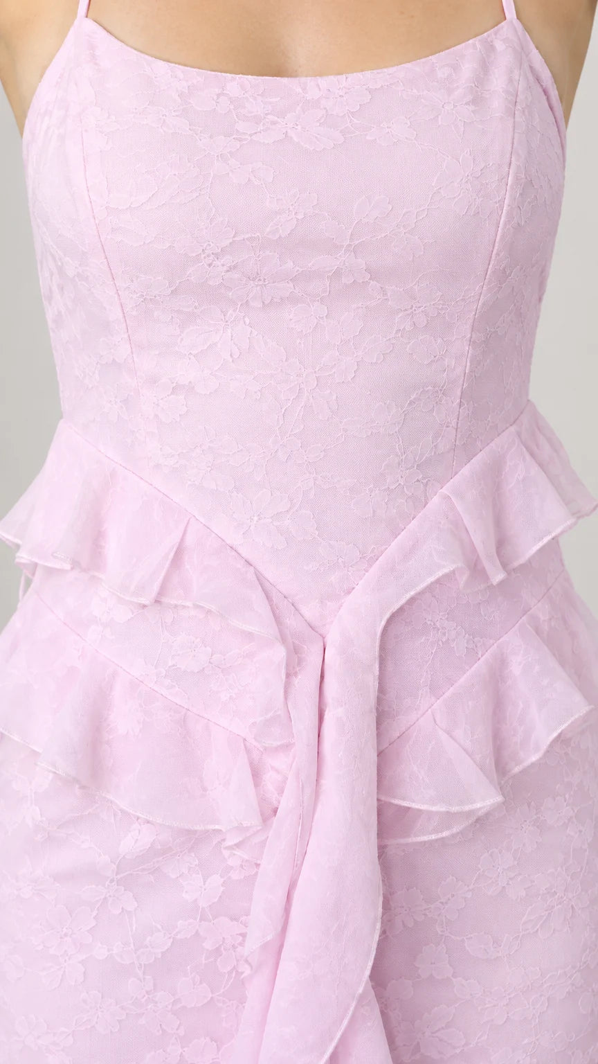Close-up detail of pastel pink floral jacquard texture and layered waist ruffles