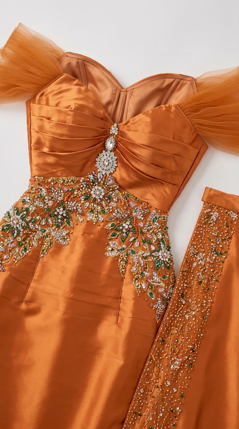 Close-up detail of sweetheart neckline and crystal beaded embroidery on orange gown