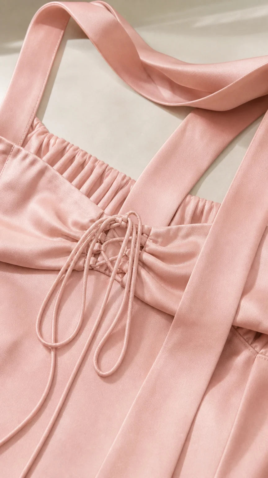 Close-up detail of Blush Pink satin dress showing back lace-up closure and ribbon straps