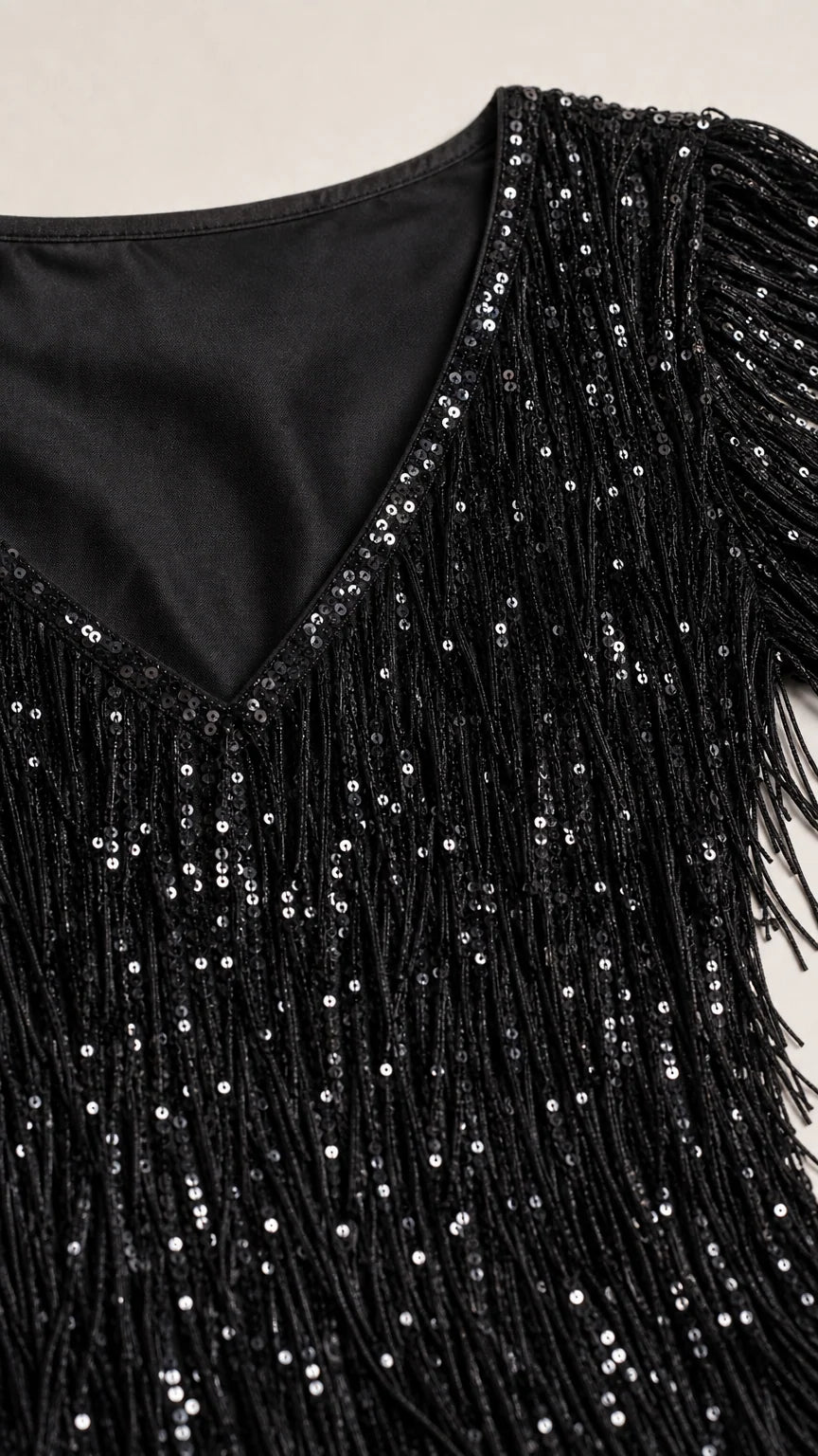 Close-up detail of V-neckline and black sequin fringe texture