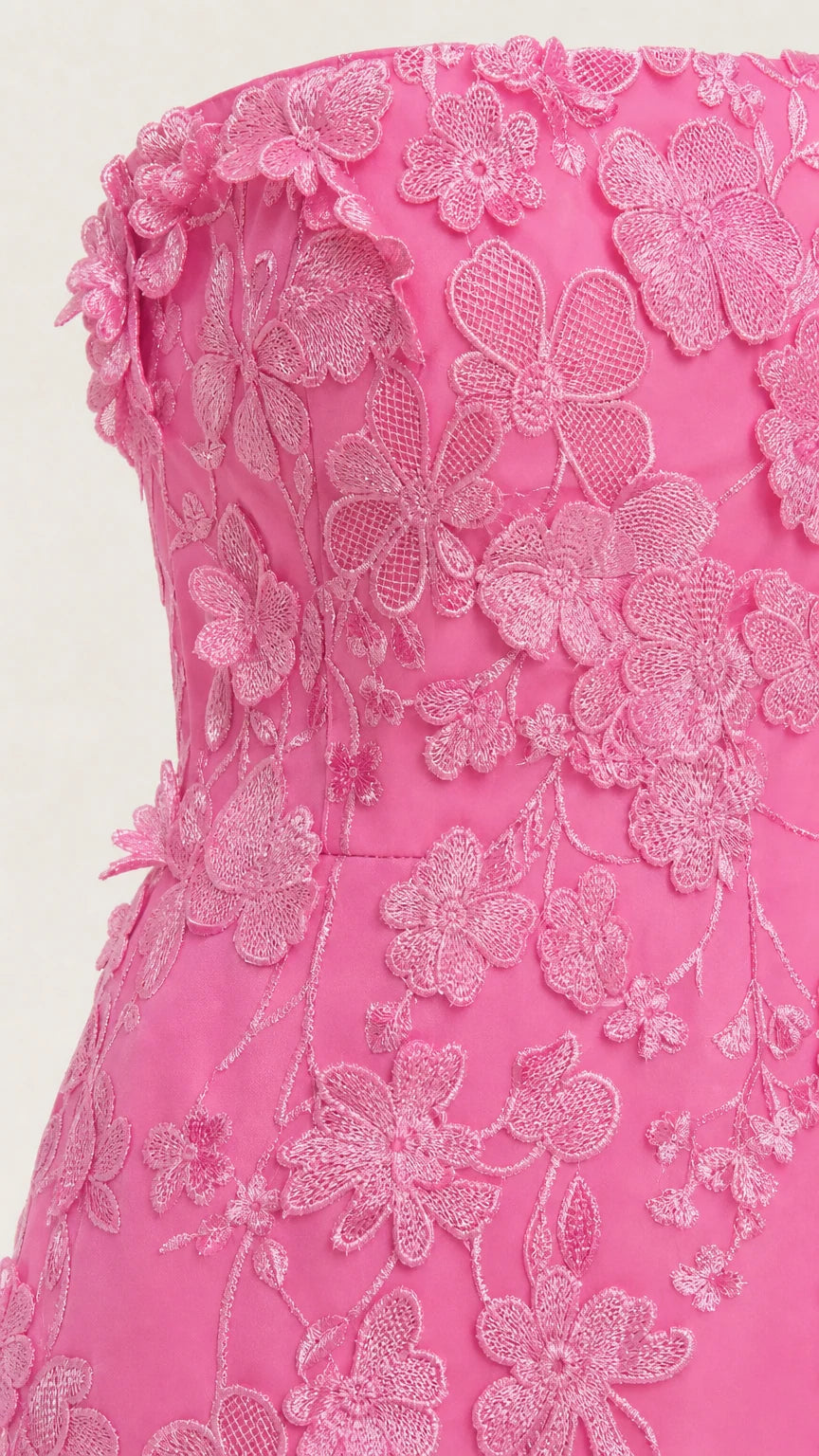 Close-up detail of textured floral appliques on pink bodice