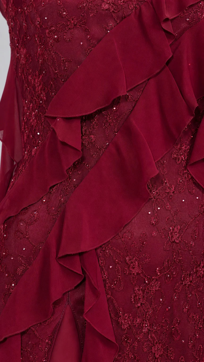 Close-up detail of burgundy lace fabric and cascading ruffles