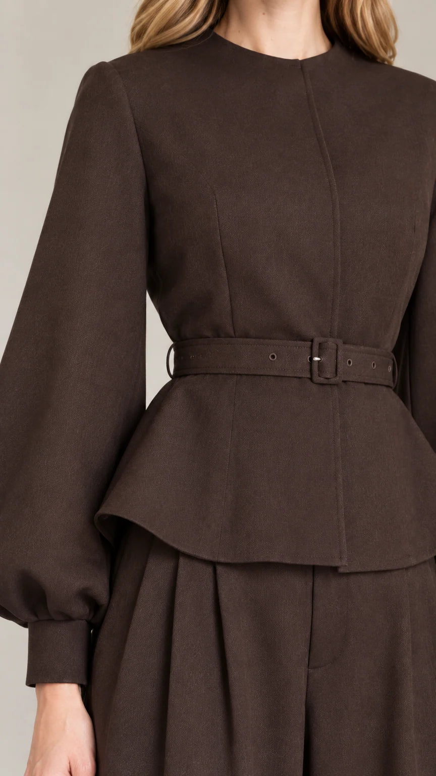 Close-up detail of Dark Brown peplum top showing fabric texture, neckline, and matching belt buckle