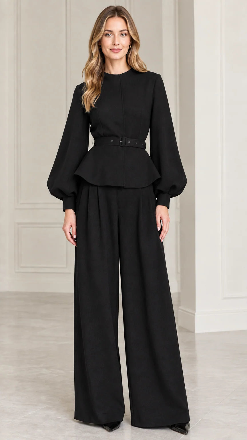 Full-length studio shot of model wearing Black belted peplum top and wide-leg pants set