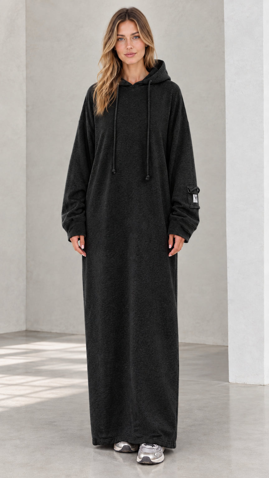 Front view of model wearing heather black oversized maxi hoodie dress