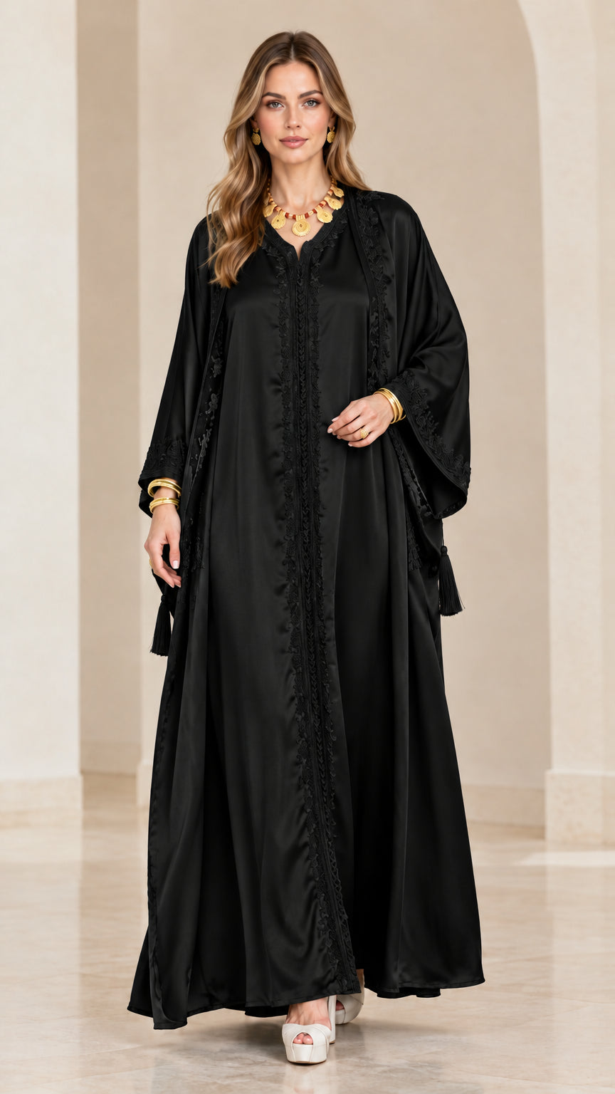 Front view of model wearing a black satin embroidered kaftan maxi dress