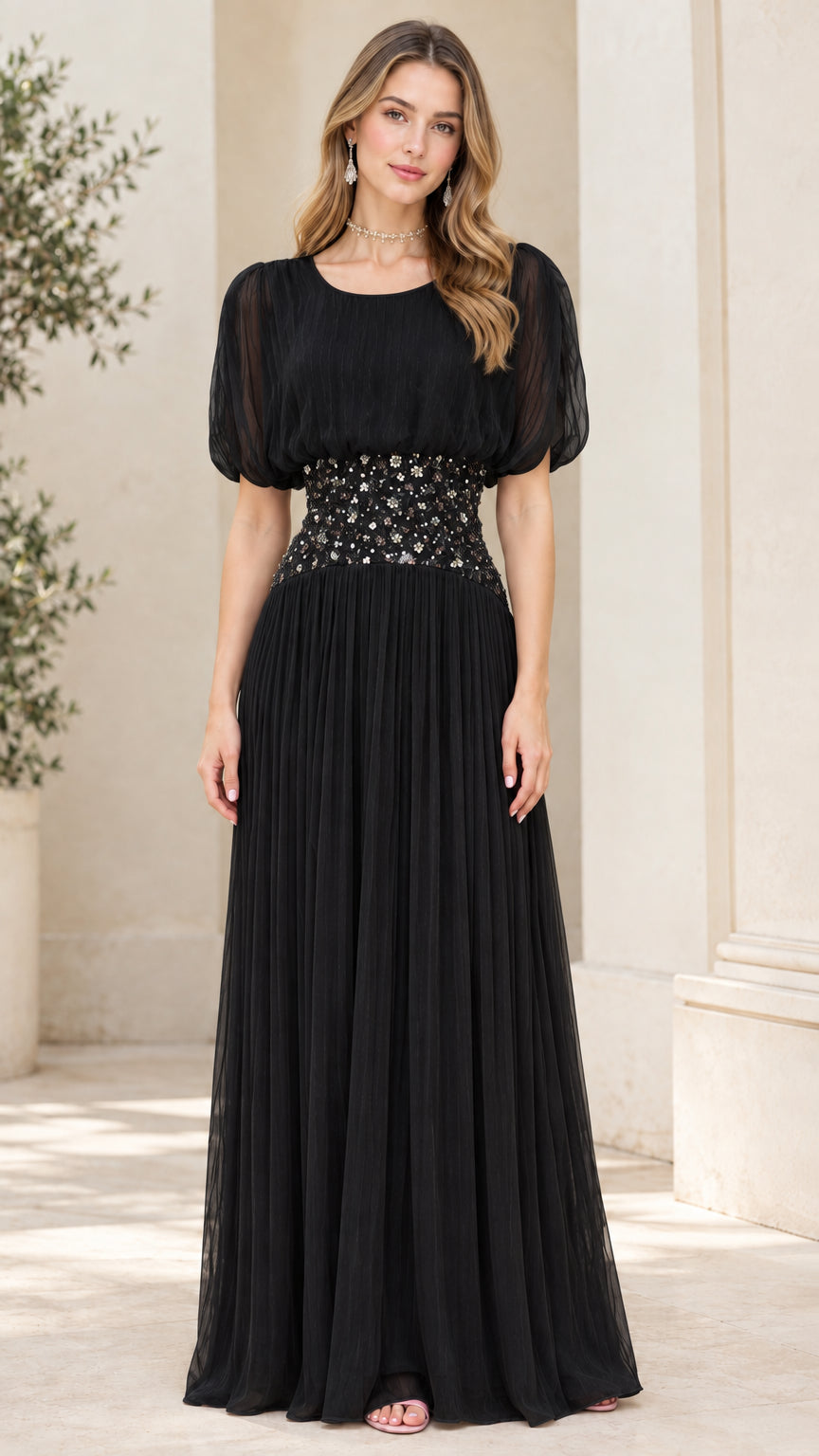 Front view of black pleated chiffon maxi dress with embellished waistband