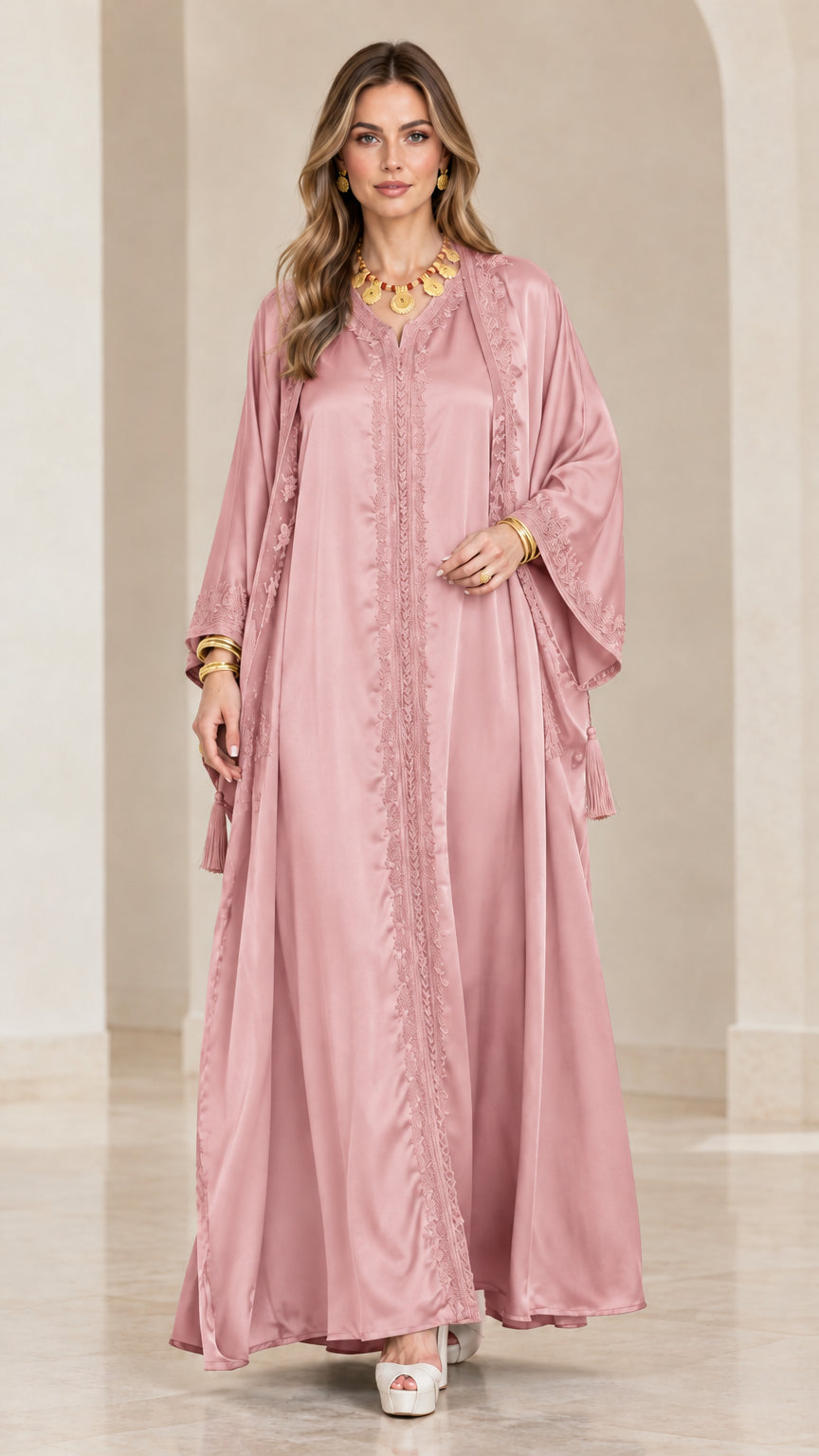 Front view of model wearing a dusty pink satin embroidered kaftan maxi dress