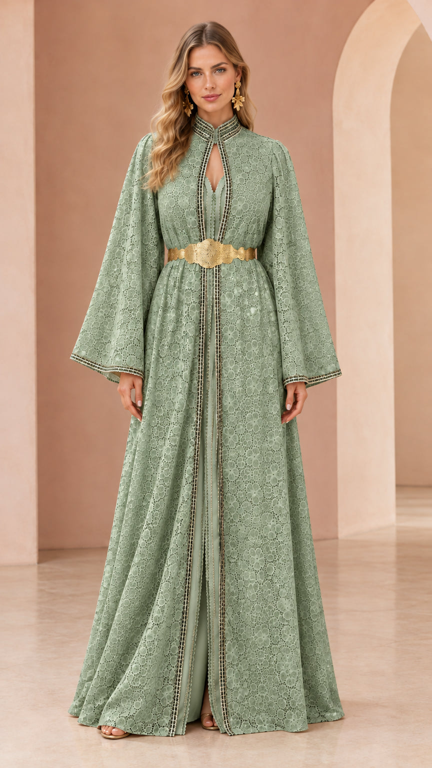 Woman wearing sage green floral lace kaftan maxi dress with gold belt