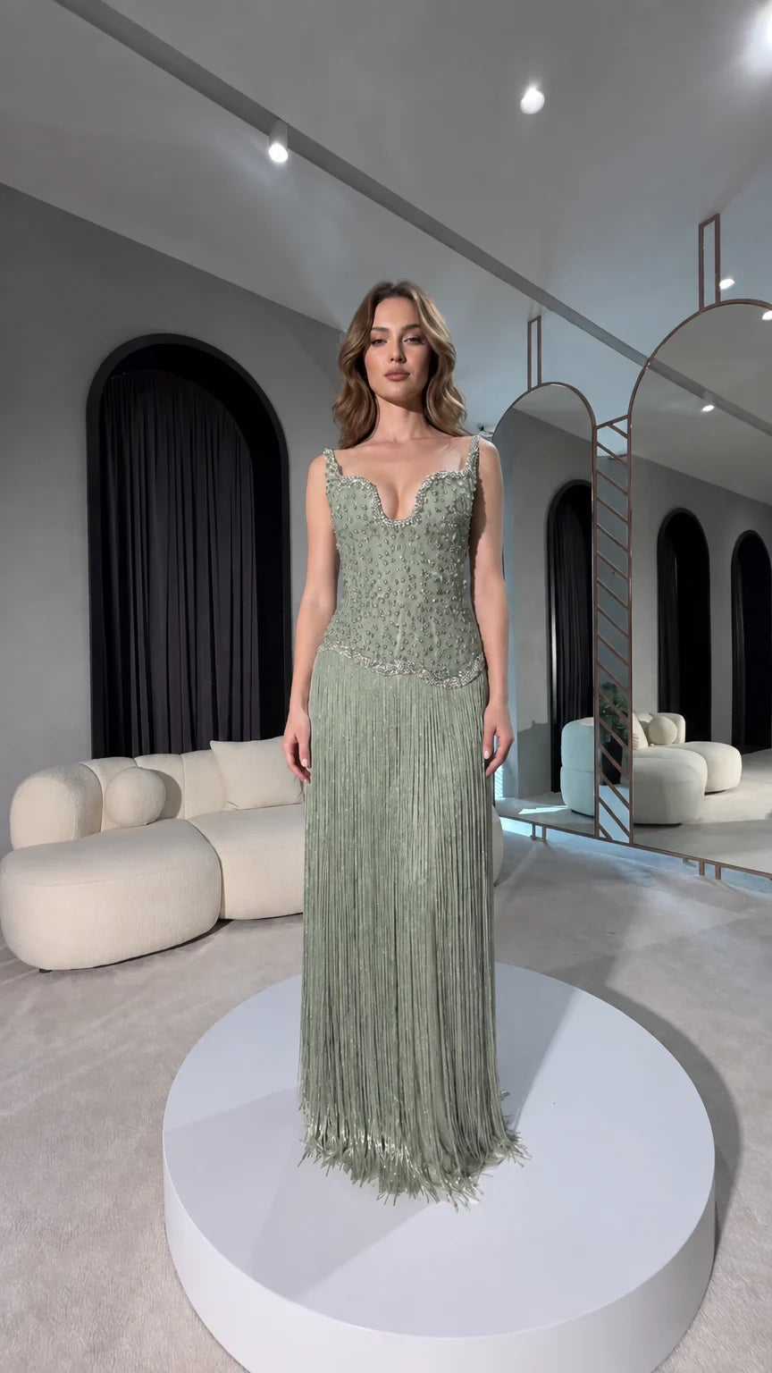 Front view of sage green beaded corset maxi gown with fringe detail