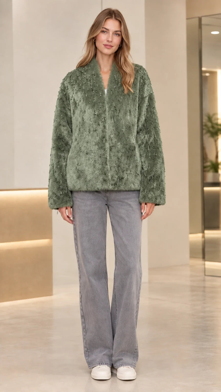 Front view of model wearing sage green beaded faux fur jacket