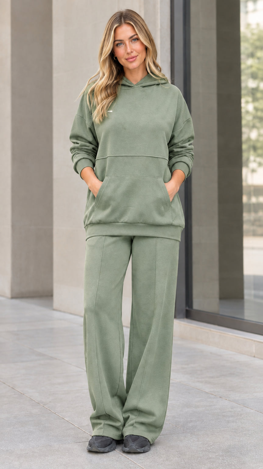 Front view of woman wearing sage green hoodie and wide-leg sweatpants matching set