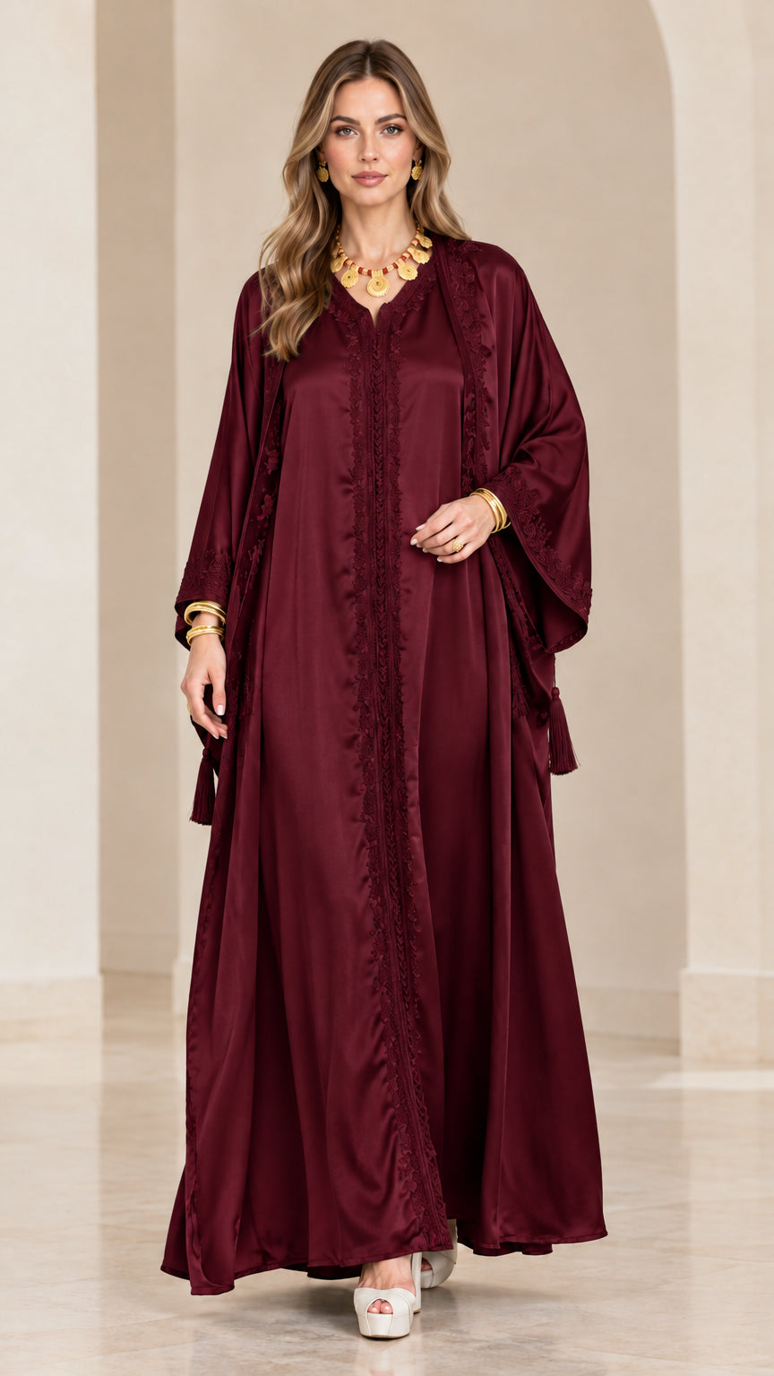 Front view of model wearing a burgundy wine satin embroidered kaftan maxi dress