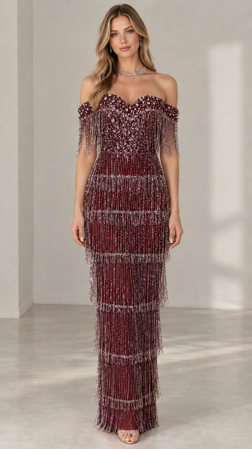 Model wearing deep burgundy off-the-shoulder beaded fringe column evening dress