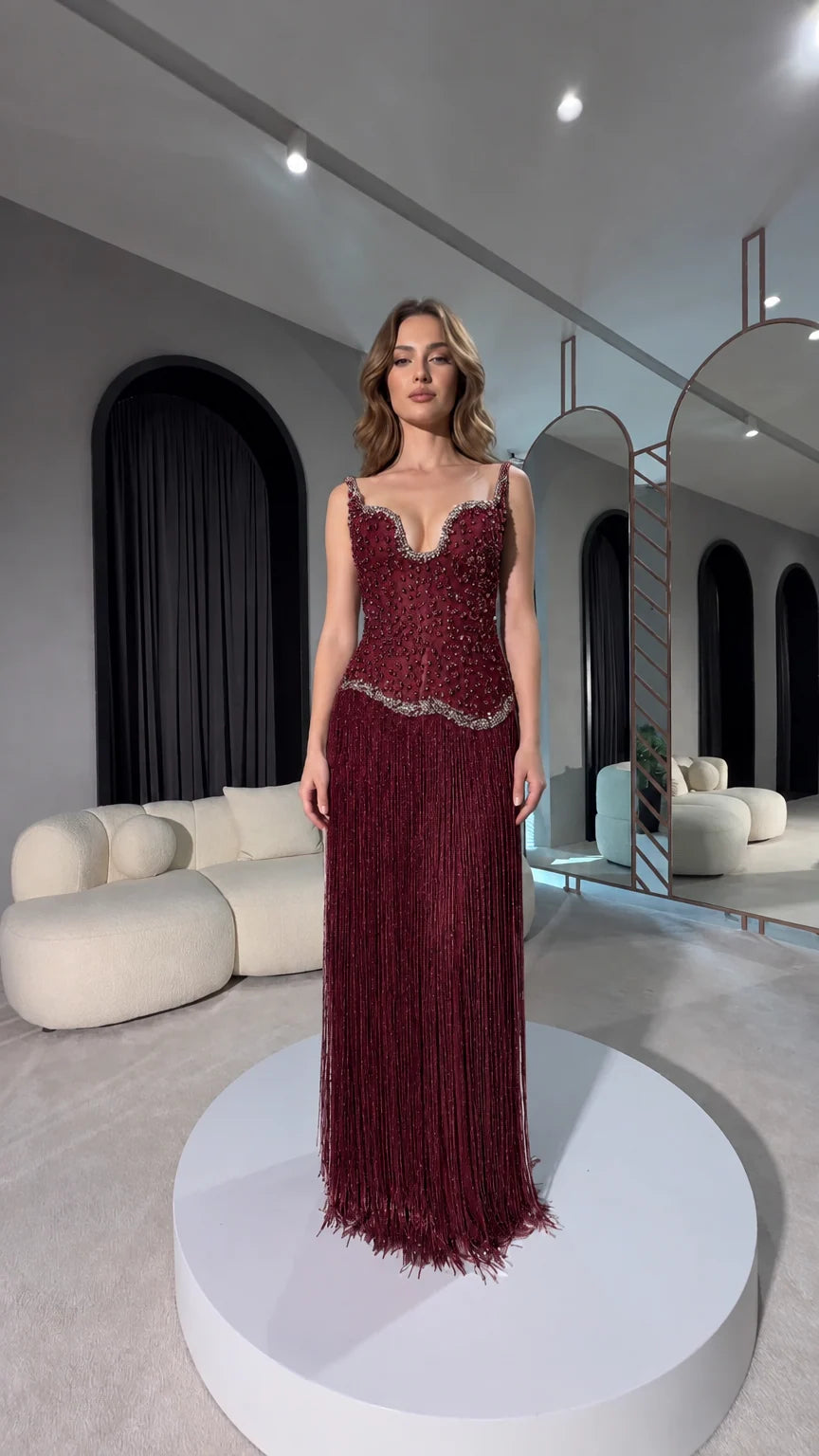 Front view of burgundy red beaded corset fringe evening gown
